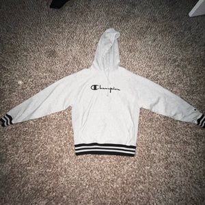 Gray champion hoodie with black and gray lining on end of sleeves